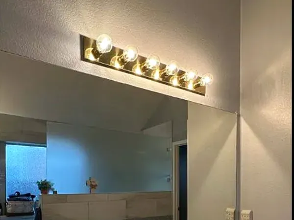 After: the same wall with a large mirror installed