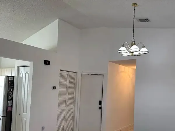Open-plan living area with freshly painted walls and ceiling