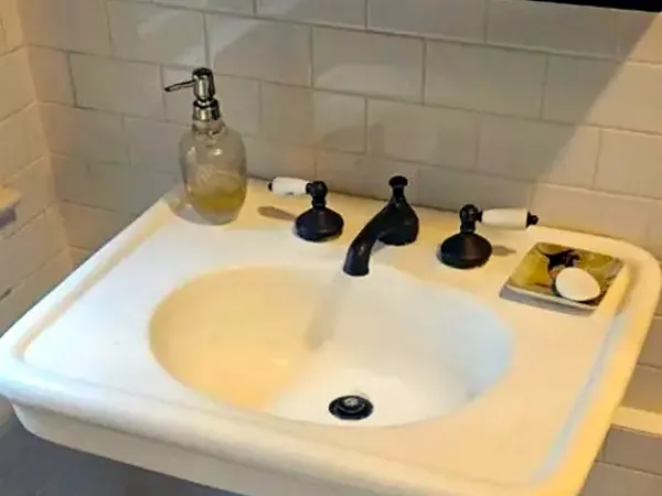 Before: old pedestal sink and faucet