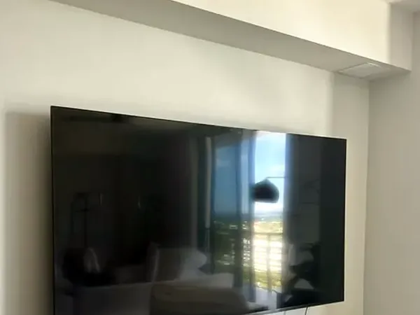 Flat-screen TV mounted on a living-room wall