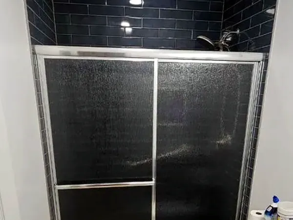 After: the same shower with a sliding glass door